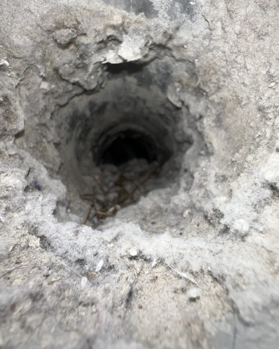 Dryer vent pipe clogged with lint before cleaning