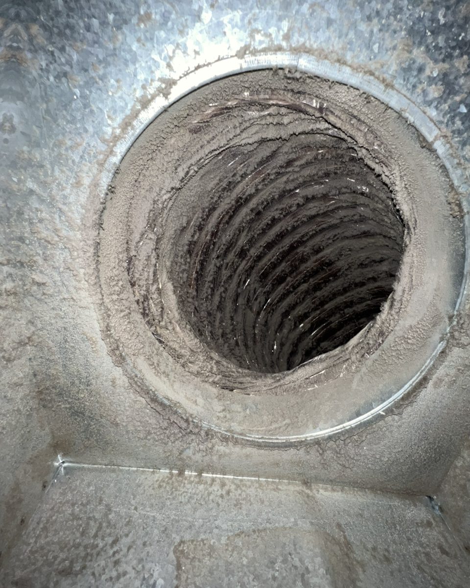 Dusty supply duct opening before cleaning
